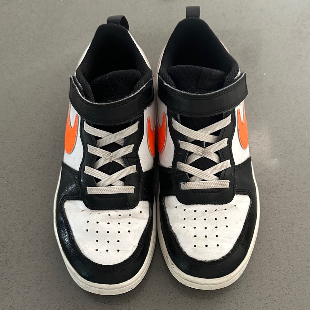 Nike Kids Black and White Sneakers with Orange Swoosh